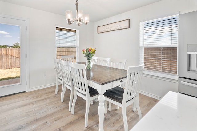 dining space featuring a chandelier and light wood-type flooring