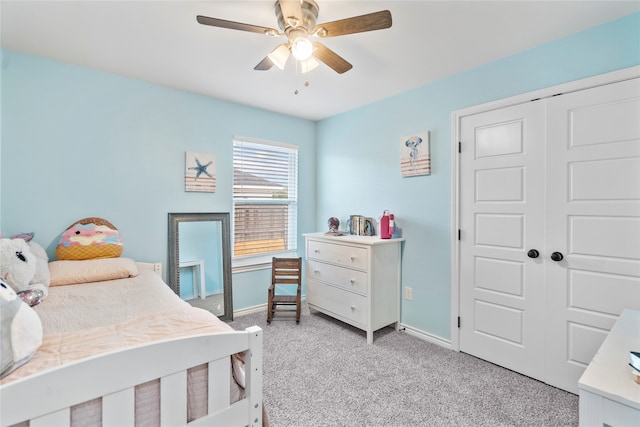 bedroom with ceiling fan, a closet, and light colored carpet