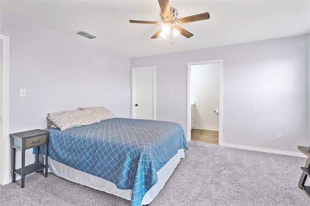 carpeted bedroom featuring ceiling fan and connected bathroom