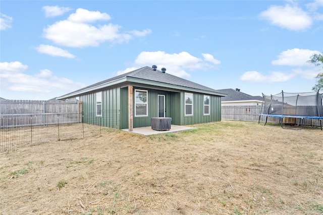 back of house featuring a trampoline, a patio, and central air condition unit