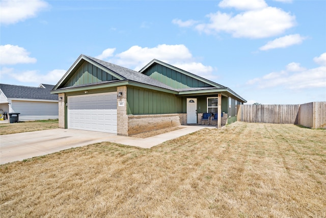 craftsman-style home featuring a porch, a garage, and a front yard