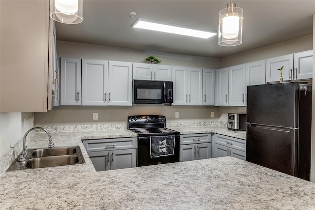 kitchen featuring sink, black appliances, and hanging light fixtures