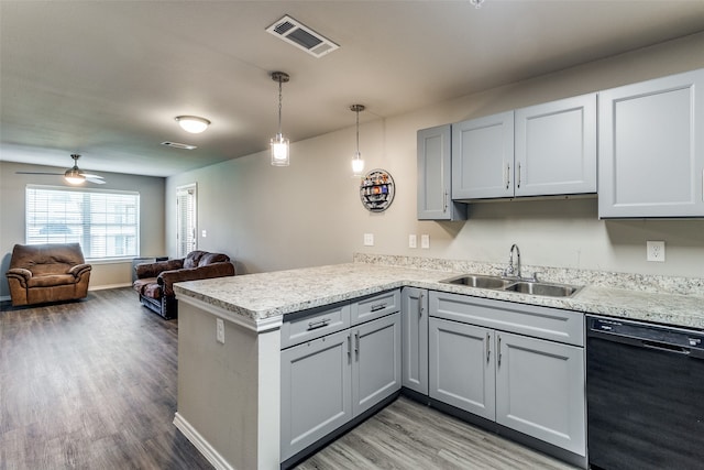 kitchen featuring ceiling fan, dishwasher, sink, kitchen peninsula, and wood-type flooring