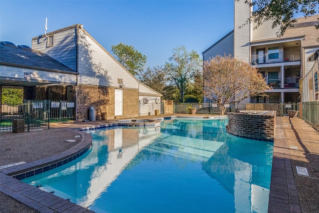 view of swimming pool featuring an in ground hot tub