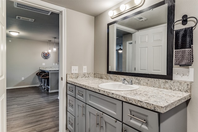 bathroom with hardwood / wood-style floors and vanity