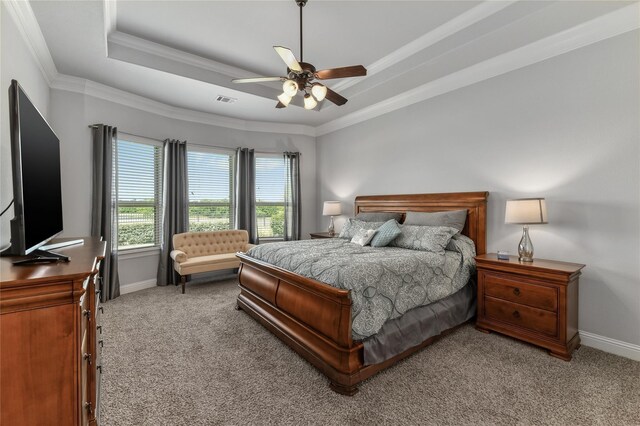 bedroom featuring carpet floors, a raised ceiling, ceiling fan, and crown molding