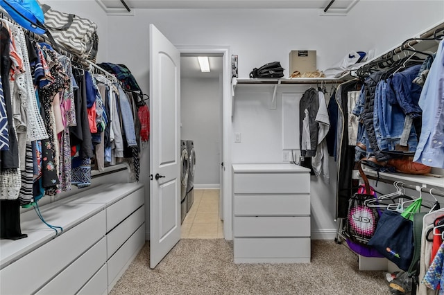 spacious closet with washing machine and dryer and light carpet