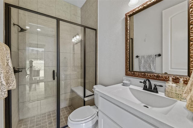 bathroom featuring vanity, toilet, and walk in shower