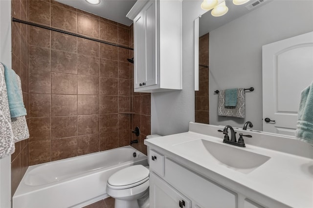 full bathroom with vanity, toilet, and tiled shower / bath