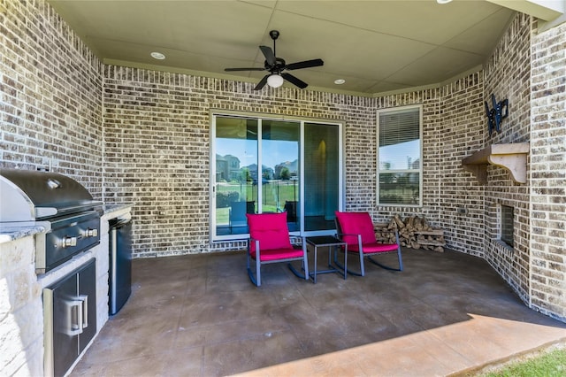 view of patio with area for grilling, ceiling fan, and a grill