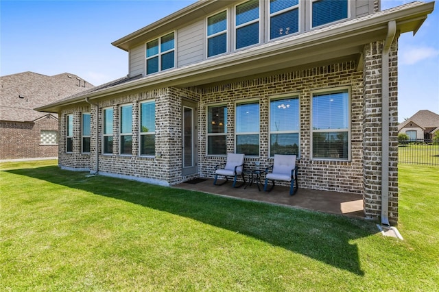 back of house with a yard and a patio