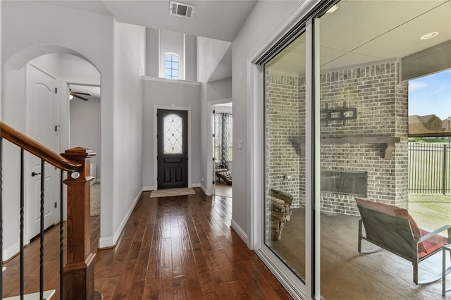 foyer entrance with ceiling fan and dark hardwood / wood-style flooring