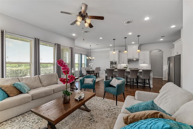 living room featuring dark hardwood / wood-style floors, a wealth of natural light, and ceiling fan