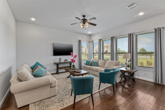 living room featuring ceiling fan and dark wood-type flooring