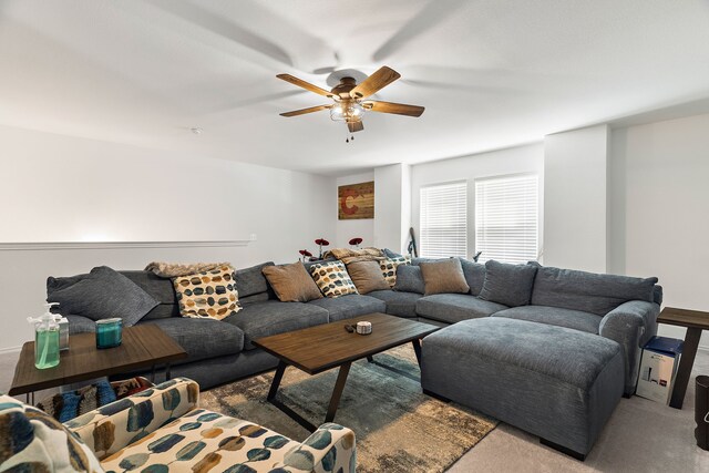 living room with ceiling fan and carpet