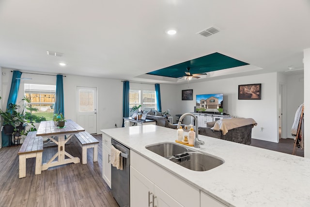 kitchen with dishwasher, dark hardwood / wood-style flooring, white cabinetry, and a healthy amount of sunlight