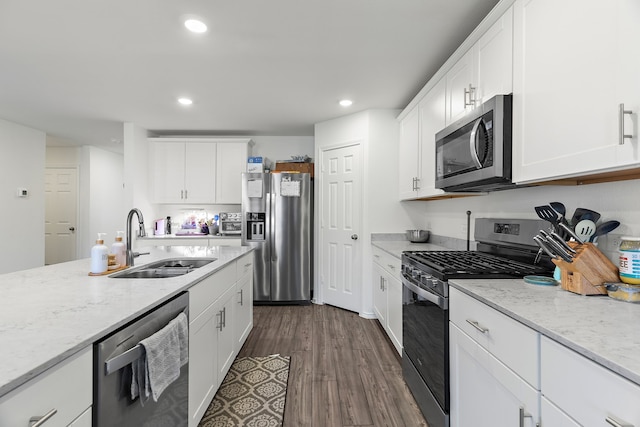 kitchen featuring sink, white cabinetry, stainless steel appliances, and dark wood-type flooring