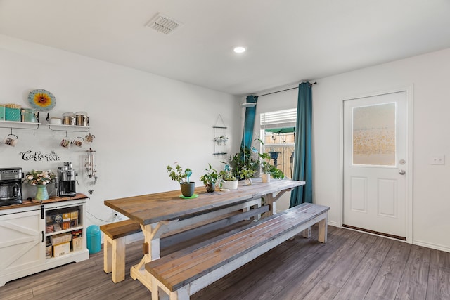 dining space with hardwood / wood-style floors