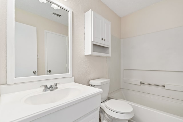 full bathroom with shower / tub combination, vanity, a textured ceiling, and toilet