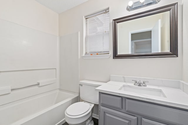 full bathroom with  shower combination, vanity, a textured ceiling, and toilet