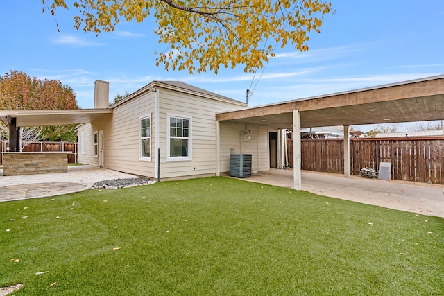 rear view of house with a yard, a patio area, and central air condition unit