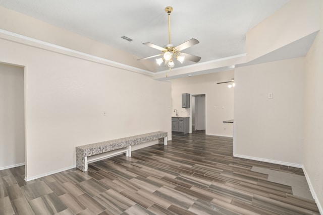 spare room with ceiling fan, dark hardwood / wood-style flooring, and sink