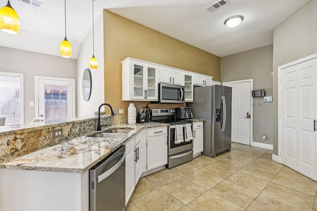 kitchen with sink, hanging light fixtures, appliances with stainless steel finishes, white cabinets, and light stone counters