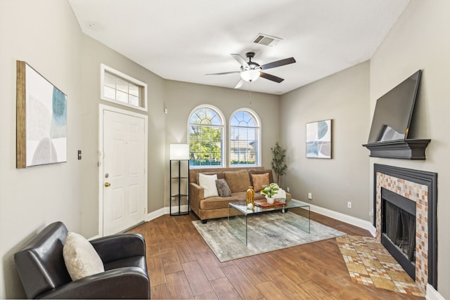 living room with ceiling fan and dark hardwood / wood-style floors