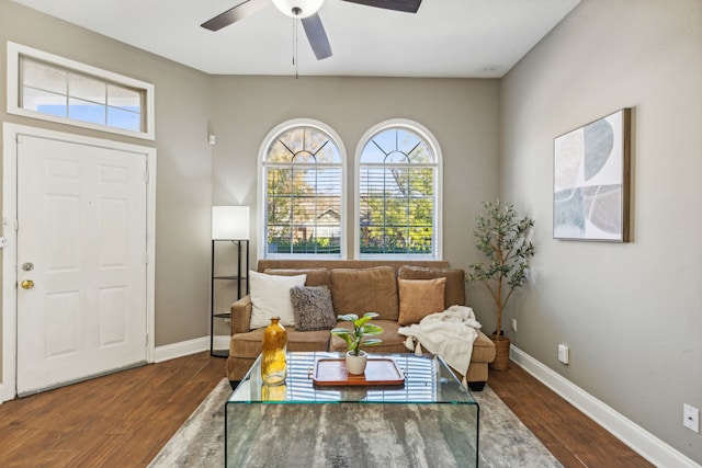 living room with dark wood-type flooring, a wealth of natural light, and ceiling fan