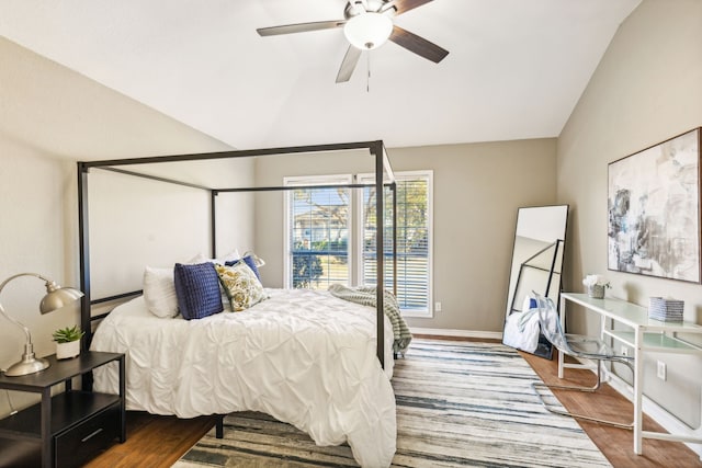 bedroom with ceiling fan, lofted ceiling, and hardwood / wood-style floors