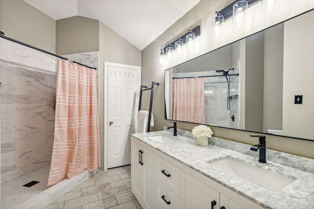 bathroom featuring curtained shower, vanity, and lofted ceiling