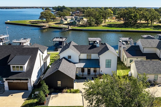 birds eye view of property with a water view