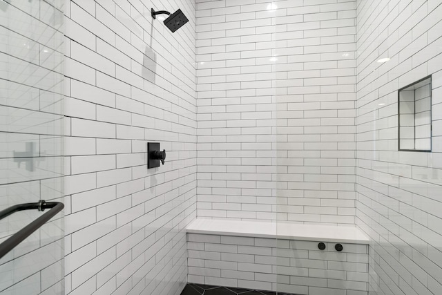 bathroom with tiled shower