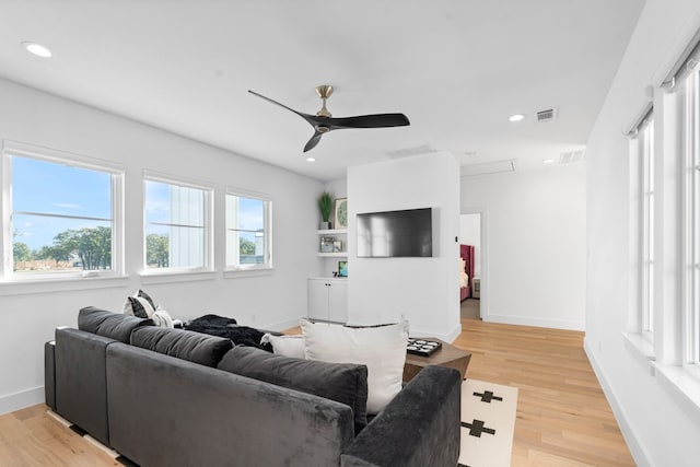 living room with hardwood / wood-style flooring and ceiling fan