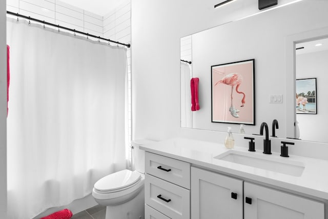 full bathroom featuring toilet, shower / tub combo, vanity, and tile patterned floors