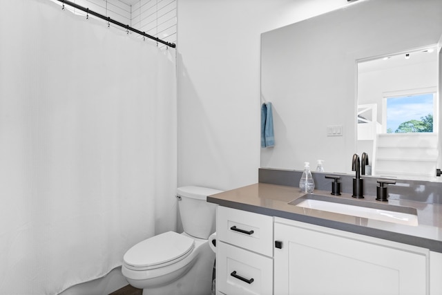 bathroom with vanity, a shower with shower curtain, and toilet