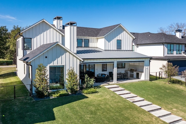 back of house with a lawn and a patio area