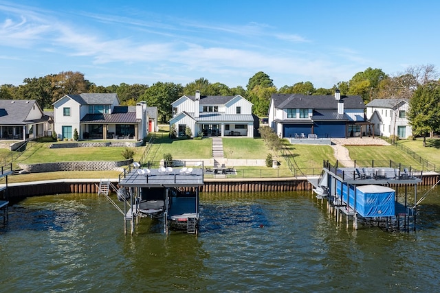 dock area with a lawn and a water view