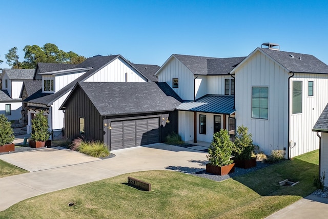 modern inspired farmhouse featuring a garage and a front yard