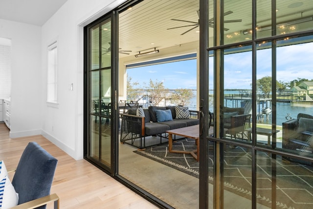 doorway featuring a water view and hardwood / wood-style flooring