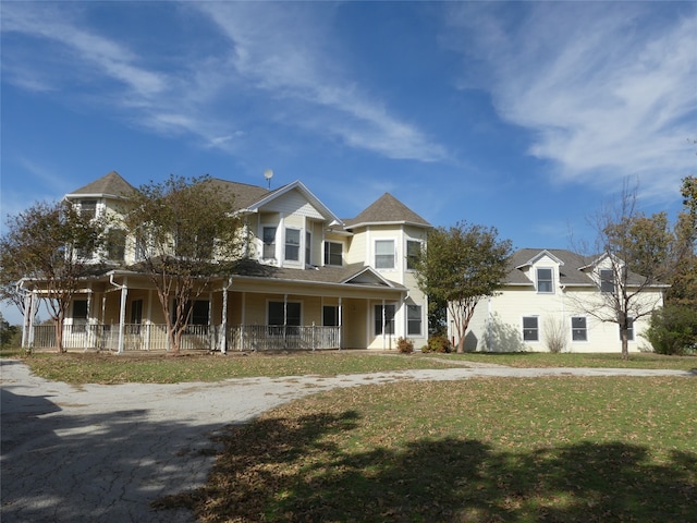 view of front of property with a porch and a front lawn