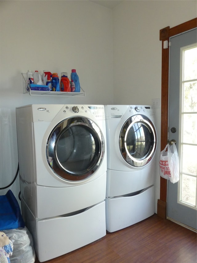 washroom featuring washing machine and clothes dryer and hardwood / wood-style floors