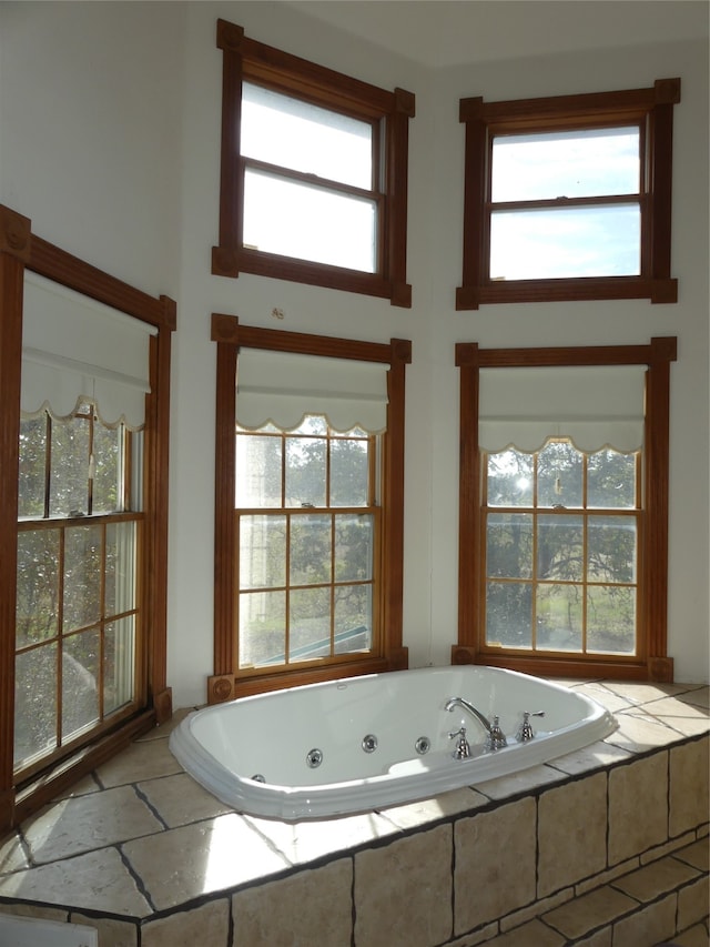 bathroom with a relaxing tiled tub