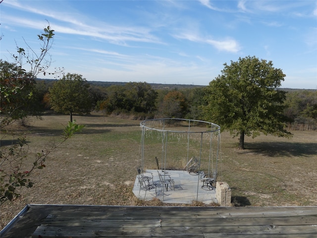 view of yard featuring a patio and a rural view