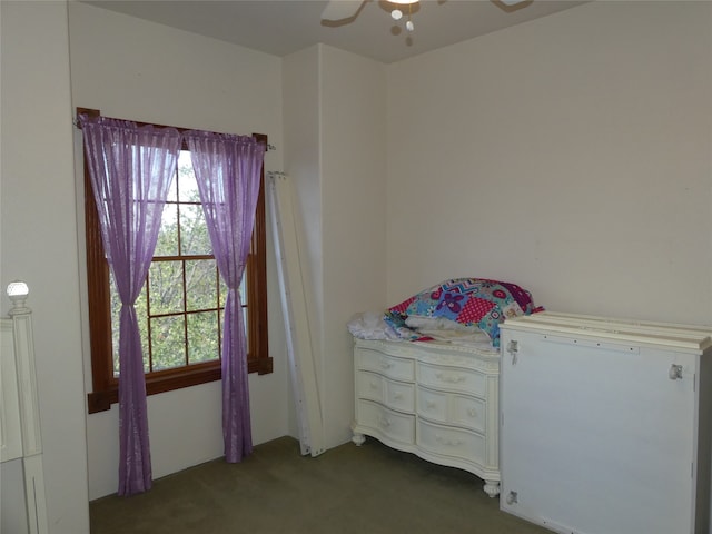 bedroom featuring dark colored carpet and ceiling fan