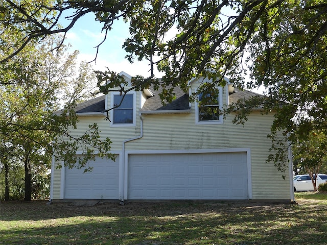 view of side of property with a garage