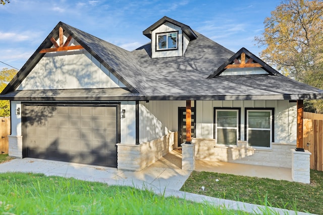 view of front of property with covered porch and a garage