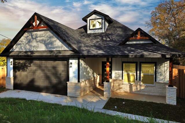 view of front of home with a porch and a garage