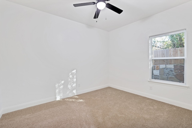 carpeted spare room featuring ceiling fan