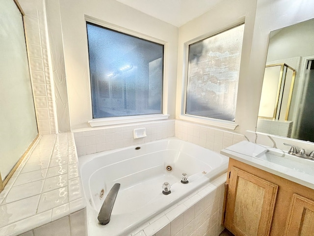 bathroom with vanity and independent shower and bath